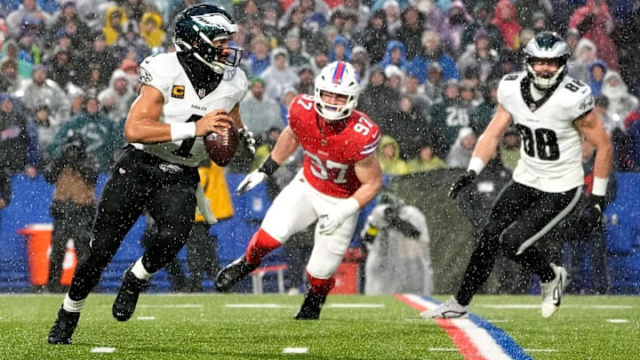 Dec 28, 2025; Orchard Park, New York, USA; Philadelphia Eagles quarterback Jalen Hurts (1) scrambles against Buffalo Bills defensive end Joey Bosa (97) during the first quarter  at Highmark Stadium. 