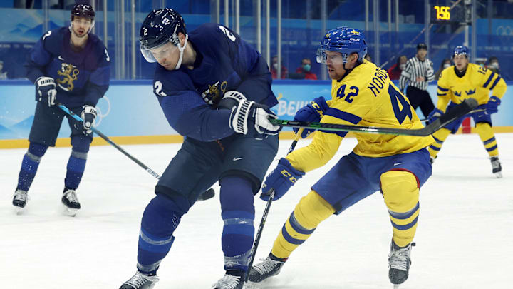 Feb 13, 2022; Beijing, China; Joakim Nordstrom of Sweden in action with Ville Pokka of Finland in men s ice hockey group C play during the Beijing 2022 Olympic Winter Games at National Indoor Stadium. Mandatory Credit: Jonathan Ernst/Reuters via Imagn Images