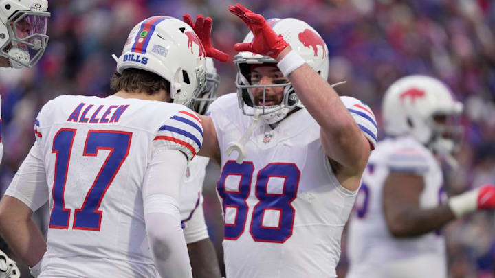 Bills tight end Dawson Knox high fives quarterback Josh Allen after one of Allen's three rushing touchdowns on the day. 