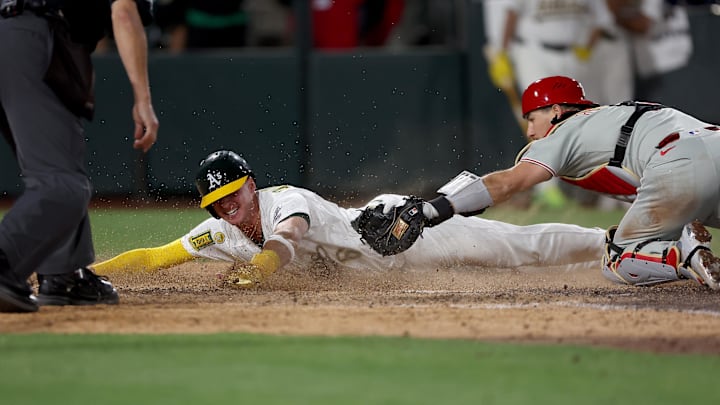May 24, 2025; West Sacramento, California, USA; Athletics pitch runner Logan Davidson (6) is tagged out by Philadelphia Phillies catcher J.T. Realmuto (10) during the tenth inning at Sutter Health Park. Mandatory Credit: Dennis Lee-Imagn Images May 24, 2025; West Sacramento, California, USA; Athletics pitch runner Logan Davidson (6) is tagged out by Philadelphia Phillies catcher J.T. Realmuto (10) during the tenth inning at Sutter Health Park. Mandatory Credit: Dennis Lee-Imagn Images