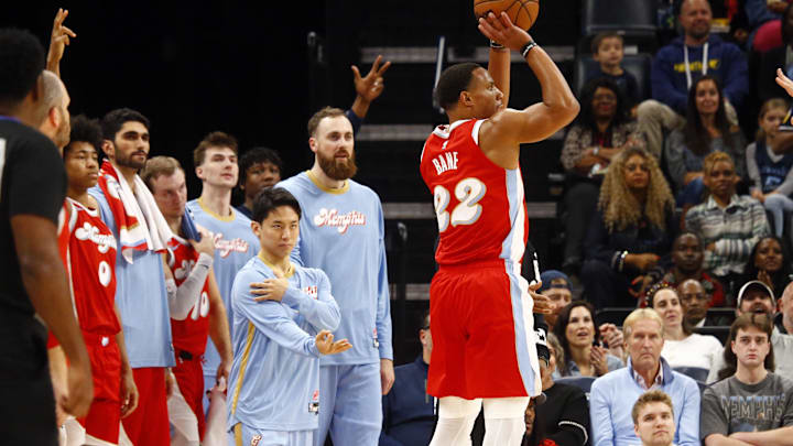 Nov 17, 2024; Memphis, Tennessee, USA; Memphis Grizzlies guard Desmond Bane (22) shoots for three as guard Yuki Kawamura (17) and the Memphis Grizzlies bench react during the first half against the Denver Nuggets at FedExForum. Mandatory Credit: Petre Thomas-Imagn Images Nov 17, 2024; Memphis, Tennessee, USA; Memphis Grizzlies guard Desmond Bane (22) shoots for three as guard Yuki Kawamura (17) and the Memphis Grizzlies bench react during the first half against the Denver Nuggets at FedExForum. Mandatory Credit: Petre Thomas-Imagn Images