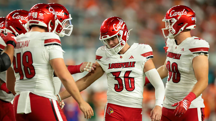 Oct 17, 2025; Miami Gardens, Florida, USA; Louisville Cardinals kicker Cooper Ranvier (36) celebrates with teammates after an extra point conversion against the Miami Hurricanes during the first quarter at Hard Rock Stadium. Mandatory Credit: Sam Navarro-Imagn Images Oct 17, 2025; Miami Gardens, Florida, USA; Louisville Cardinals kicker Cooper Ranvier (36) celebrates with teammates after an extra point conversion against the Miami Hurricanes during the first quarter at Hard Rock Stadium. Mandatory Credit: Sam Navarro-Imagn Images