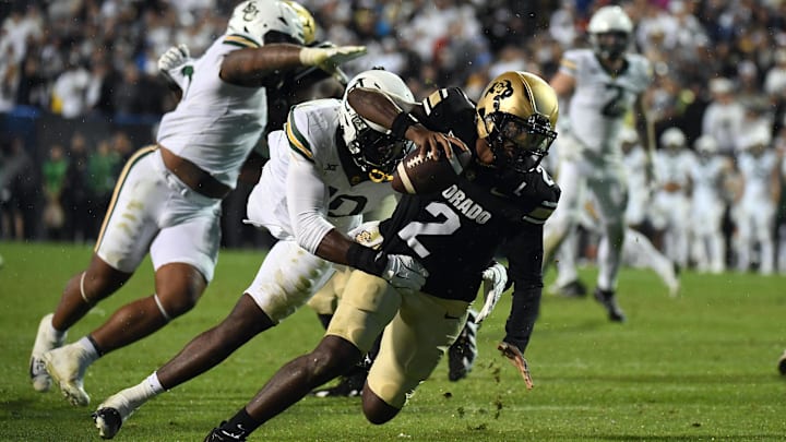 Sep 21, 2024; Boulder, Colorado, USA; Colorado Buffaloes quarterback Shedeur Sanders (2) is sacked by Baylor Bears linebacker Steve Linton (10) during the second half at Folsom Field.  