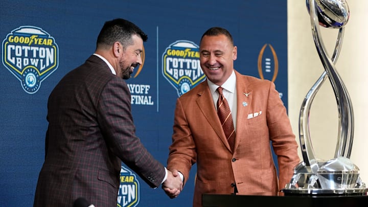 Ohio State Buckeyes head coach Ryan Day and Texas Longhorns head coach Steve Sarkisian shake hands following a press conference at AT&T Stadium prior to the College Football Playoff semifinal at the Cotton Bowl Classic in Arlington, Texas on Jan. 9, 2025.