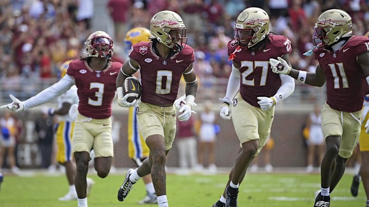 Oct 11, 2025; Tallahassee, Florida, USA; Florida State Seminoles safety Earl Little Jr. (0), defensive back Ashlynd Barker (27), defensive back Edwin Joseph (3), and defensive back Ja'Bril Rawls (11) celebrate after an interception during the first half of the game against the Pittsburgh Panthers at Doak S. Campbell Stadium. Mandatory Credit: Melina Myers-Imagn Images