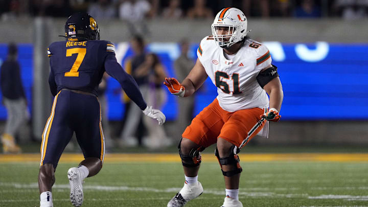Oct 5, 2024; Berkeley, California, USA; Miami Hurricanes offensive lineman Francis Mauigoa (61) blocks against California Golden Bears linebacker David Reese (7) during the first quarter at California Memorial Stadium. Mandatory Credit: Darren Yamashita-Imagn Images