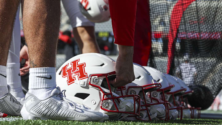 General view of Houston Cougars players picking up helmets on the sideline