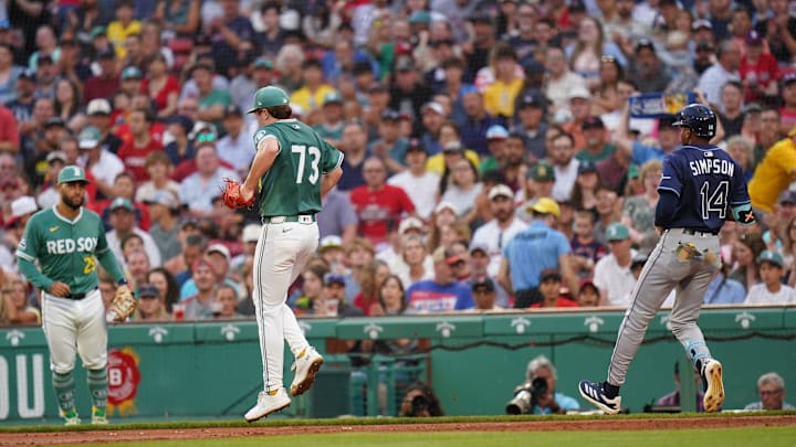 Jul 11, 2025; Boston, Massachusetts, USA; Boston Red Sox pitcher Hunter Dobbins (73) is hurt after a play at first against Tampa Bay Rays outfielder Chandler Simpson (14) in the second inning at Fenway Park. Mandatory Credit: David Butler II-Imagn Images
