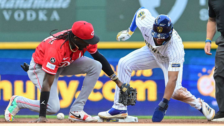 Sep 28, 2025; Milwaukee, Wisconsin, USA; Milwaukee Brewers center fielder Jackson Chourio (11) steals second base as Cincinnati Reds shortstop Elly De La Cruz (44) drops the ball in the fourth inning at American Family Field. Mandatory Credit: Benny Sieu-Imagn Images