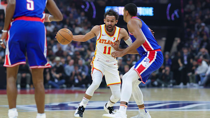 Nov 18, 2024; Sacramento, California, USA; Atlanta Hawks guard Trae Young (11) dribbles the ball against Sacramento Kings forward Keegan Murray (13) during the first quarter at Golden 1 Center. Mandatory Credit: Sergio Estrada-Imagn Images
