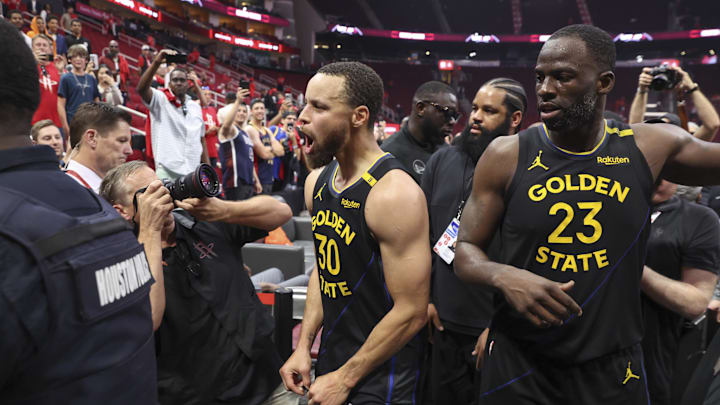 May 4, 2025; Houston, Texas, USA; Golden State Warriors guard Stephen Curry (30) and forward Draymond Green (23) walk off the court after game seven of the first round for the 2025 NBA Playoffs against the Houston Rockets at Toyota Center. Mandatory Credit: Troy Taormina-Imagn Images