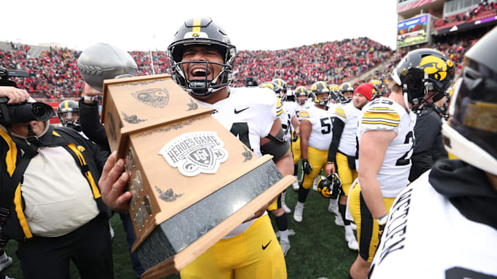 Nov 24, 2023; Lincoln, Nebraska, USA; Iowa Hawkeyes defensive lineman Yahya Black (94) carries the Heroes Trophy after beating the Nebraska Cornhuskers at Memorial Stadium. Mandatory Credit: Reese Strickland-Imagn Images Nov 24, 2023; Lincoln, Nebraska, USA; Iowa Hawkeyes defensive lineman Yahya Black (94) carries the Heroes Trophy after beating the Nebraska Cornhuskers at Memorial Stadium. Mandatory Credit: Reese Strickland-Imagn Images