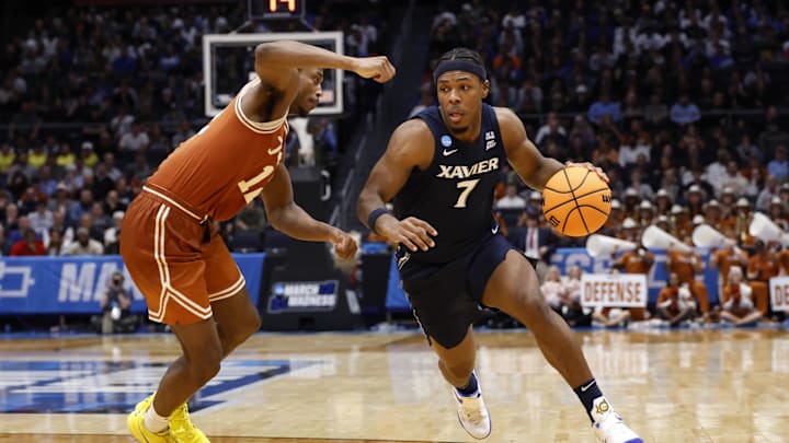 Mar 19, 2025; Dayton, OH, USA; Xavier Musketeers guard Ryan Conwell (7) dribbles the ball defended by Texas Longhorns guard Tramon Mark (12) in the second half at UD Arena. Mandatory Credit: Rick Osentoski-Imagn Images Mar 19, 2025; Dayton, OH, USA; Xavier Musketeers guard Ryan Conwell (7) dribbles the ball defended by Texas Longhorns guard Tramon Mark (12) in the second half at UD Arena. Mandatory Credit: Rick Osentoski-Imagn Images