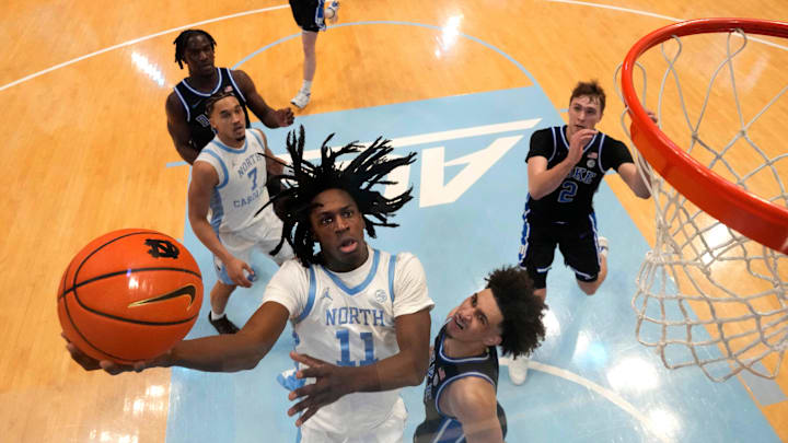 Mar 8, 2025; Chapel Hill, North Carolina, USA; North Carolina Tar Heels guard Ian Jackson (11) shoots as Duke Blue Devils guard Tyrese Proctor (5) defends in the second half at Dean E. Smith Center. Mandatory Credit: Bob Donnan-Imagn Images