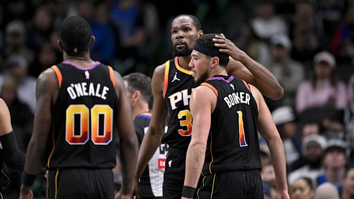 Mar 9, 2025; Dallas, Texas, USA; Phoenix Suns forward Kevin Durant (35) helps up guard Devin Booker (1) from the floor during the second half of the game against the Dallas Mavericks at the American Airlines Center. Mandatory Credit: Jerome Miron-Imagn Images