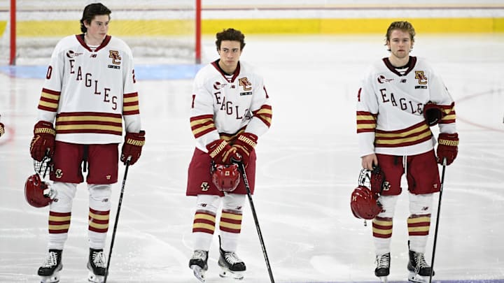 Feb 28, 2025; Chestnut Hill, MA, USA; Boston College forward Dean Letourneau (20), defenseman Aram Minnetian (17) and forward Gentry Shamburger (14) stand on the blue line during the national anthem before a game against the University of New Hampshire Wildcats at Conte Forum. Mandatory Credit: Eric Canha-Imagn Images