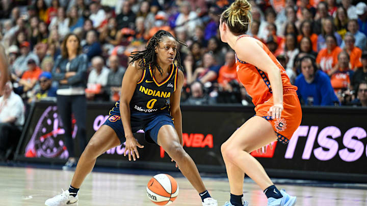 Sep 22, 2024; Uncasville, Connecticut, USA; Indiana Fever guard Kelsey Mitchell (0) dribbles the ball defended by Connecticut Sun guard Marina Mabrey (4) during game one of the first round of the 2024 WNBA Playoffs at Mohegan Sun Arena. Mandatory Credit: Mark Smith-Imagn Images