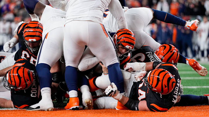 Cincinnati Bengals quarterback Joe Burrow (9) scores a touchdown on a QB sneak up the middle in the fourth quarter of the NFL Week 17 game between the Cincinnati Bengals and the Denver Broncos at Paycor Stadium in downtown Cincinnati on Saturday, Dec. 28, 2024. The Bengals took a 30-24 win in overtime to remain in the post season chase.