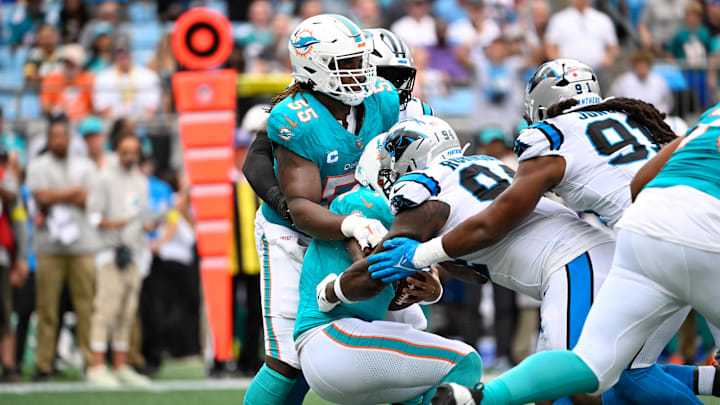 Oct 5, 2025; Charlotte, North Carolina, USA; Miami Dolphins quarterback Tua Tagovailoa (1) is sacked by Carolina Panthers defensive end A'Shawn Robinson (94) and linebacker Patrick Jones II (91) in the second quarter at Bank of America Stadium. Mandatory Credit: Bob Donnan-Imagn Images Oct 5, 2025; Charlotte, North Carolina, USA; Miami Dolphins quarterback Tua Tagovailoa (1) is sacked by Carolina Panthers defensive end A'Shawn Robinson (94) and linebacker Patrick Jones II (91) in the second quarter at Bank of America Stadium. Mandatory Credit: Bob Donnan-Imagn Images