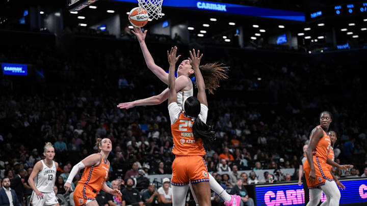 Aug 25, 2025; Brooklyn, New York, USA; New York Liberty forward Breanna Stewart (30) shoots the ball while defended by Connecticut Sun forward Aneesah Morrow (24) during the first half at Barclays Center. Mandatory Credit: John Jones-Imagn Images