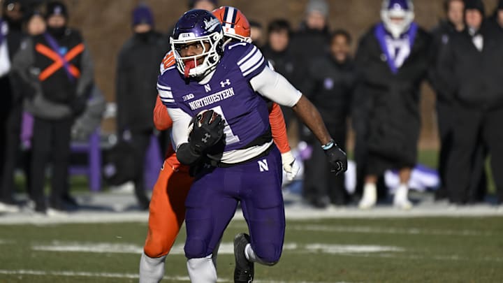 Nov 30, 2024; Chicago, Illinois, USA; Northwestern Wildcats running back Cam Porter (1) runs the ball against the Illinois Fighting Illini during the second half at Wrigley Field. Mandatory Credit: Matt Marton-Imagn Images Nov 30, 2024; Chicago, Illinois, USA; Northwestern Wildcats running back Cam Porter (1) runs the ball against the Illinois Fighting Illini during the second half at Wrigley Field. Mandatory Credit: Matt Marton-Imagn Images