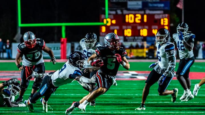 Lake Mary's Parker Perales (5) looks for running room against Dr. Phillips on Friday night in the Class 7A state semifinal. The Rams won 24-13.
