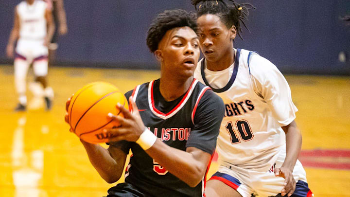 Williston High School guard Deandre Harvey (5) gets pressure from Vanguard's Jandrian Smith (10) as Vanguard takes on Williston during the Kingdom of the Sun basketball tournament at Vanguard High School in Ocala on Thursday, Dec. 28, 2023. Williston won 42-30.