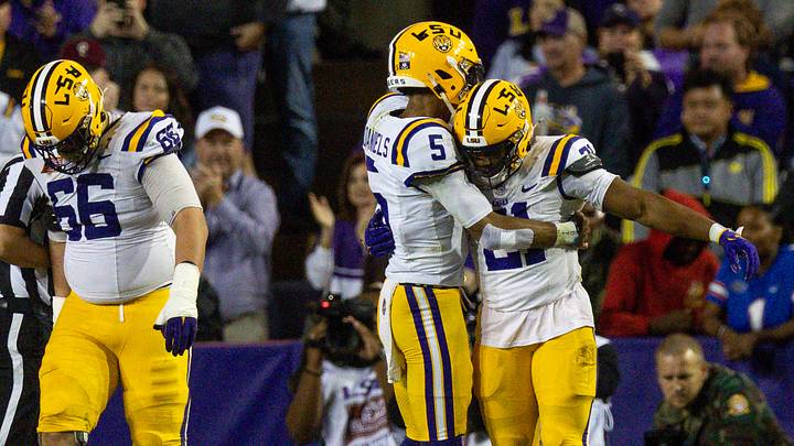 LSU Tigers running back Noah Cain is congratulated by quarterback Jayden Daniels.