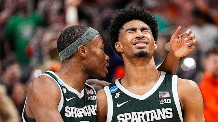 Michigan State guard Jaden Akins (3) is comforted by guard Tre Holloman (5)
