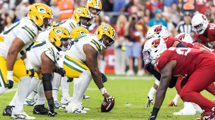 Oct 19, 2025; Glendale, Arizona, USA; General view down the line of scrimmage as Green Bay Packers center Elgton Jenkins (74) prepares to snap the ball against the Arizona Cardinals at State Farm Stadium.