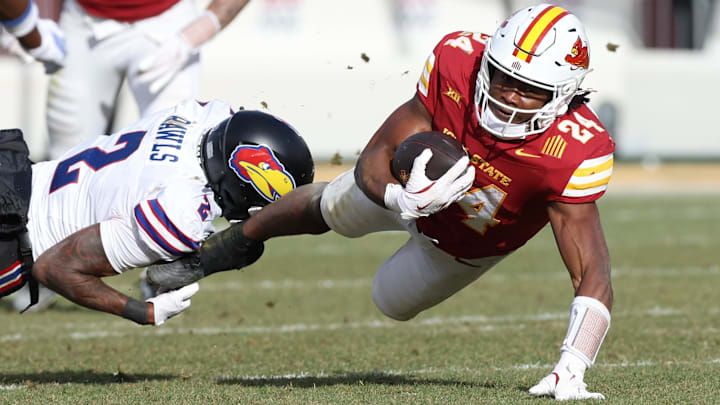 Nov 22, 2025; Ames, Iowa, USA; Kansas Jayhawks safety Lyrik Rawls (2) tackles ball carrier Iowa State Cyclones running back Abu Sama (24) during the second half at Jack Trice Stadium.