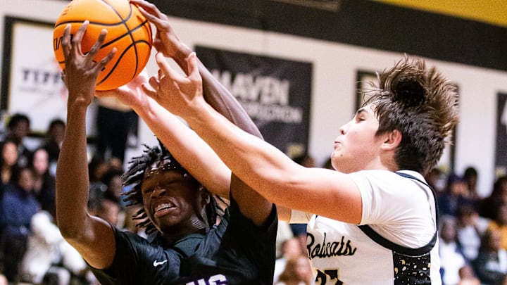 Gainesville Hurricanes Willie Brooks (1) and Buchholz Bobcats Evan Walker (22) go after a rebound in the first half. The Buchholz Bobcats hosted the Gainesville Hurricanes at Buchholz High School in Gainesville, FL on Friday, December 13, 2024. [Doug Engle/Gainesville Sun]