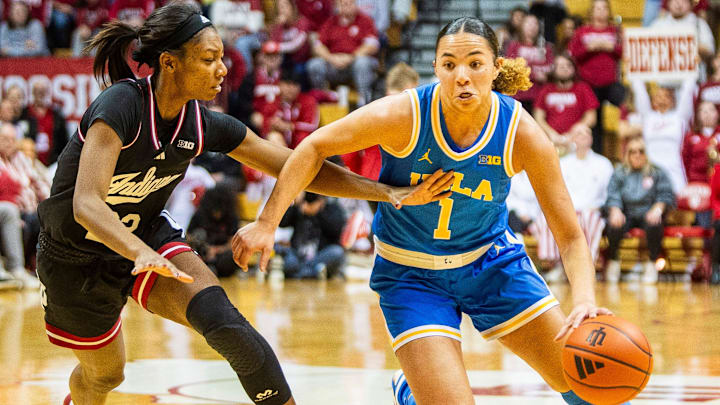 UCLA's Kiki Rice (1) drives on Indiana's Chloe Moore-McNeil (22) at Simon Skjodt Assembly Hall on Saturday, Jan. 4, 2025.