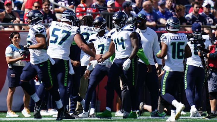 Sep 15, 2024; Foxborough, Massachusetts, USA; Seattle Seahawks wide receiver DK Metcalf (14) is congratulated after scoring a touchdown against the New England Patriots in the first quarter at Gillette Stadium. Mandatory Credit: David Butler II-Imagn Images