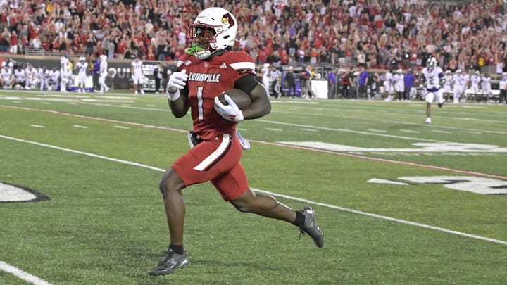 Sep 5, 2025; Louisville, Kentucky, USA;  Louisville Cardinals running back Isaac Brown (1) runs the ball for a touchdown against the James Madison Dukes during the second half at L&N Federal Credit Union Stadium. Mandatory Credit: Jamie Rhodes-Imagn Images