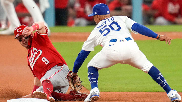 Cincinnati Reds second baseman Matt McLain (9) beats a tag from Los Angeles Dodgers shortstop Mookie Betts (50) at second base in the eighth inning of the MLB National League Wild Card Game 1 between the Los Angeles Dodgers and the Cincinnati Reds at Dodger Stadium in Los Angeles on Tuesday, Sept. 30, 2025. The Dodgers won game 1 of the series, 10-5.