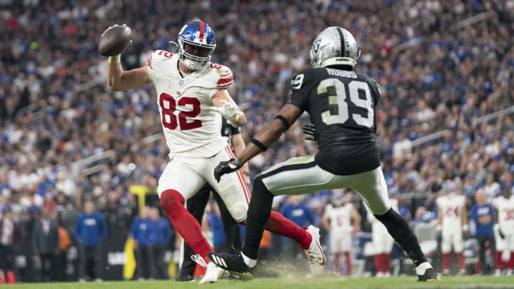 November 5, 2023; Paradise, Nevada, USA; New York Giants tight end Daniel Bellinger (82) runs the football against Las Vegas Raiders cornerback Nate Hobbs (39) during the fourth quarter at Allegiant Stadium. Mandatory Credit: Kyle Terada-USA TODAY Sports