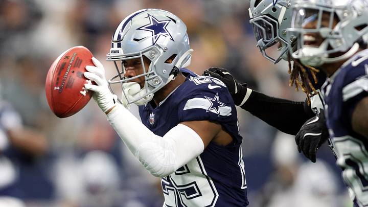Dallas Cowboys cornerback C.J. Goodwin recovers a fumble against the Washington Commanders at AT&T Stadium. 