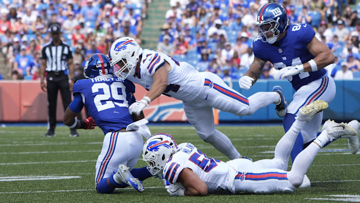 Aug 9, 2025; Orchard Park, New York, USA; Buffalo Bills linebacker Joe Andreessen (44) and Buffalo Bills linebacker Matt Milano (58) tackle New York Giants running back Tyrone Tracy Jr. (29) during the first half at Highmark Stadium