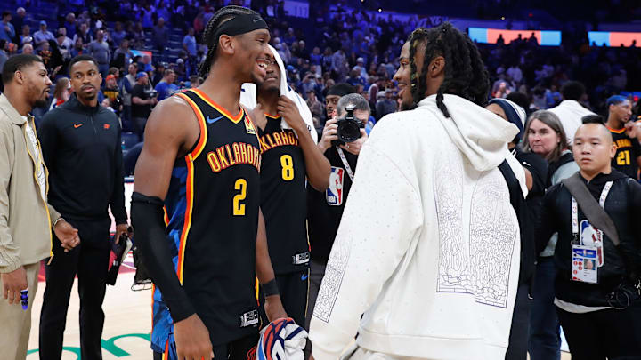Dec 29, 2024; Oklahoma City, Oklahoma, USA;  Oklahoma City Thunder guard Shai Gilgeous-Alexander (2) and Memphis Grizzlies guard Ja Morant (12) meet after their game at Paycom Center. Mandatory Credit: Alonzo Adams-Imagn Images