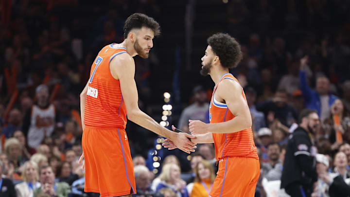 Nov 8, 2024; Oklahoma City, Oklahoma, USA; Oklahoma City Thunder forward Chet Holmgren (7) and guard Ajay Mitchell (25) high-five after a play against the Houston Rockets during the second quarter at Paycom Center. Mandatory Credit: Alonzo Adams-Imagn Images
