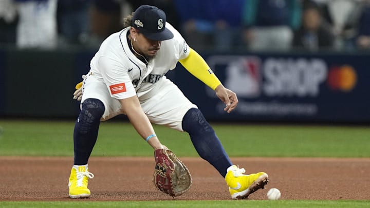 Oct 5, 2025; Seattle, Washington, USA; Seattle Mariners first baseman Josh Naylor (12) field a ball in the seventh inning against the Detroit Tigers during game two of the ALDS round for the 2025 MLB playoffs at T-Mobile Park. Mandatory Credit: Stephen Brashear-Imagn Images