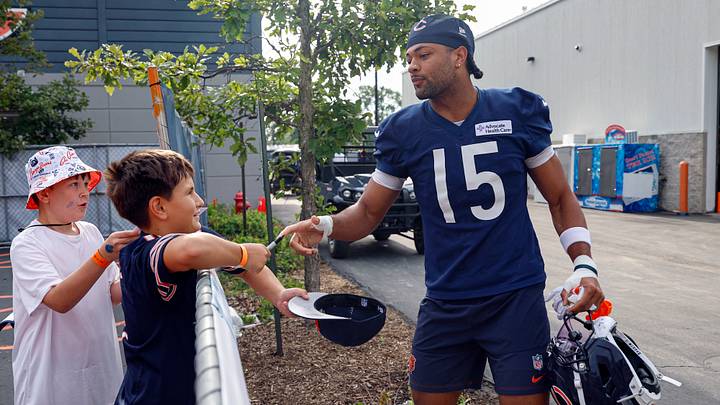 Rome Odunze signs autographs during training camp at Halas Hall. Odunze sees the chance for more 50-50 catches this year.