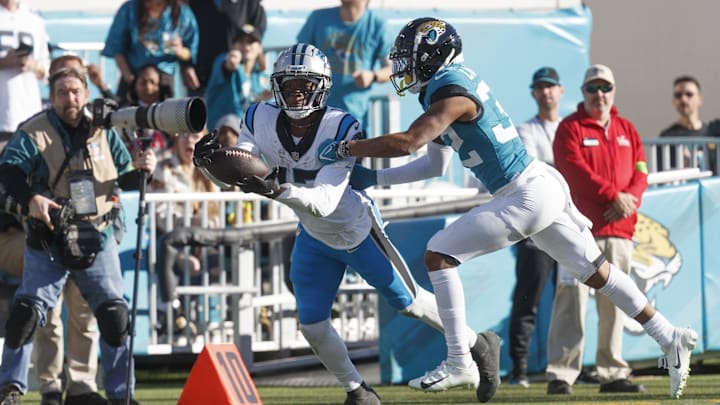 Dec 31, 2023; Jacksonville, Florida, USA; Carolina Panthers wide receiver Jonathan Mingo (15) drops a pass under pressure from cornerback Tyson Campbell (32) during the fourth quarter at EverBank Stadium. Mandatory Credit: Morgan Tencza-USA TODAY Sports