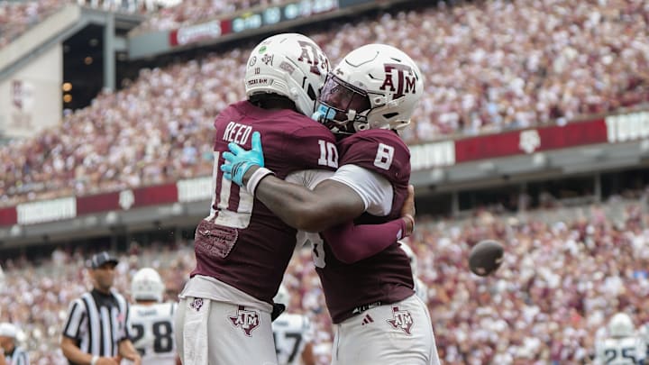Sep 6, 2025; College Station, Texas, USA; Texas A&M Aggies quarterback Marcel Reed (10) and Texas A&M Aggies running back Le'Veon Moss (8) celebrate after a touchdown during the second quarter against the Utah State Aggies at Kyle Field. Mandatory Credit: Sean Thomas-Imagn Images