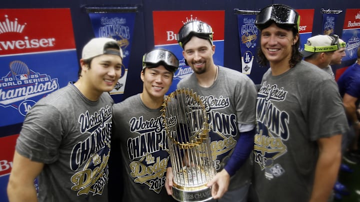 Oct 31, 2025; Toronto, Ontario, CAN; Los Angeles Dodgers two-way player Shohei Ohtani (17) and pitcher Yoshinobu Yamamoto (18) and pitcher Blake Snell (7) and pitcher Tyler Glasnow (31) celebrate with the Commissioner's Trophy in the clubhouse after defeating the Toronto Blue Jays in the 2025 MLB World Series at Rogers Centre. Mandatory Credit: John E. Sokolowski-Imagn Images