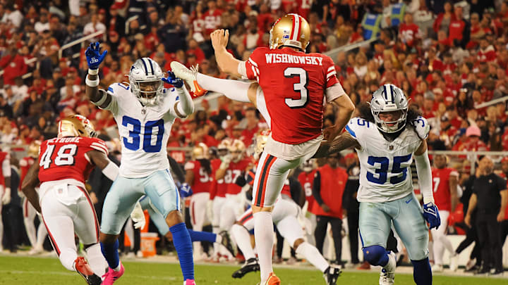 Oct 27, 2024; Santa Clara, California, USA; San Francisco 49ers punter Mitch Wishnowsky (3) punts the ball against Dallas Cowboys safety Juanyeh Thomas (30) and linebacker Marist Liufau (35)
