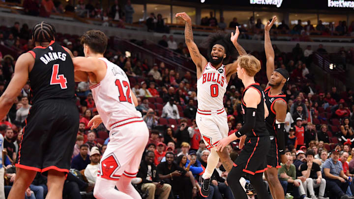 Feb 28, 2025; Chicago, Illinois, USA; Chicago Bulls guard Coby White (0) hits a three point shot and gets fouled to tie the game and send it into overtime against the Toronto Raptors at the United Center. Mandatory Credit: Patrick Gorski-Imagn Images