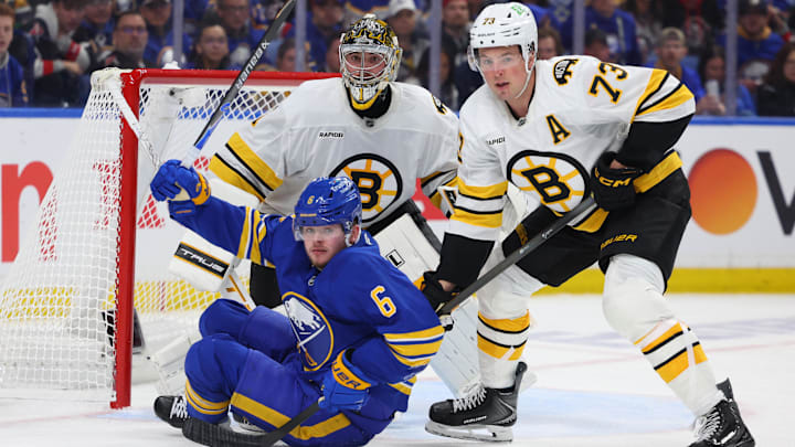 Apr 19, 2026; Buffalo, New York, USA; Boston Bruins defenseman Charlie McAvoy (73) knocks down Buffalo Sabres left wing Zach Benson (6) in front of the net as Boston Bruins goaltender Jeremy Swayman (1) watches the puck during the second period in game one of the first round of the 2026 Stanley Cup Playoffs at KeyBank Center. Mandatory Credit: Timothy T. Ludwig-Imagn Images