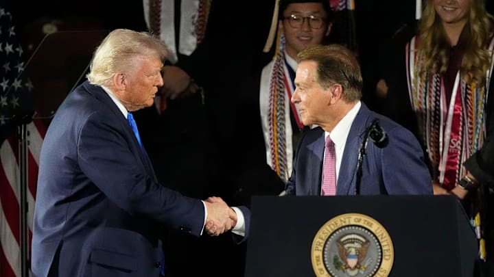President Donald Trump shakes hands with legendary Alabama football coach Nick Saban before delivering a special commencement address to University of Alabama graduates at Coleman Coliseum on May 1, 2025. Graduation occurs over the weekend.